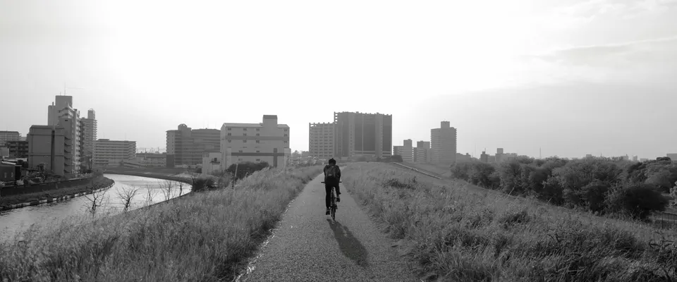 Cyclist on a quiet path at sunrise